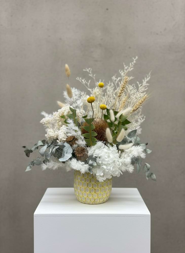 Natural toned dried flowers in yellow pot